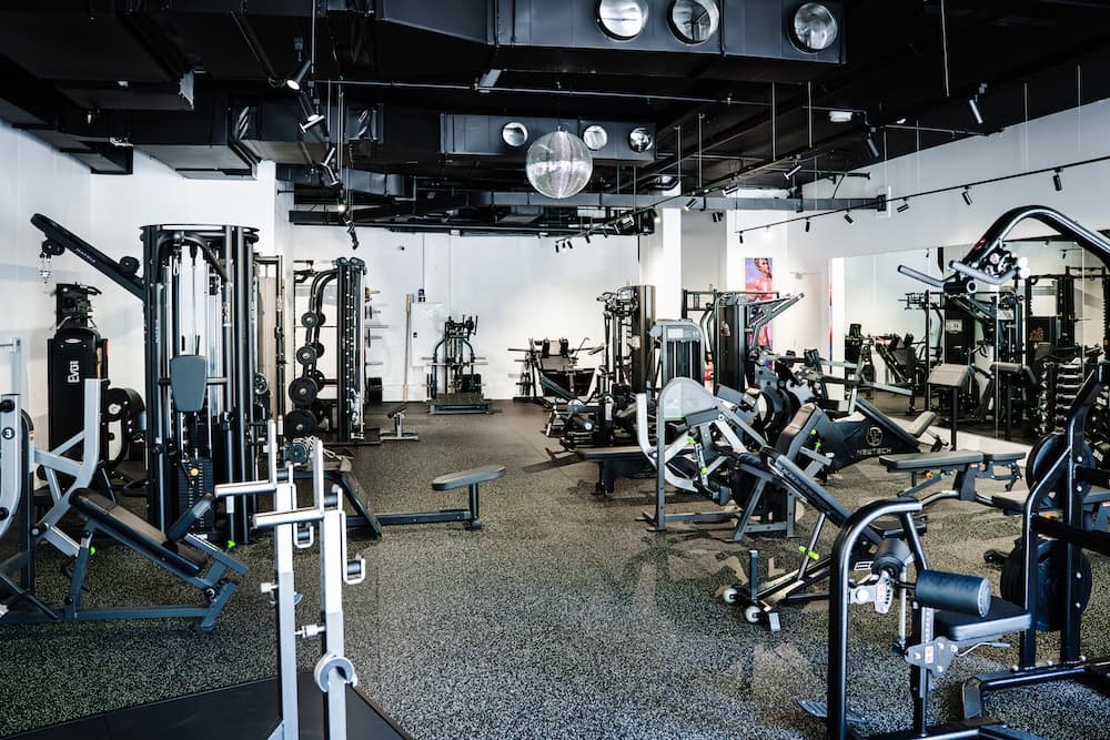 Main gym floor with extensive equipment and mirrors